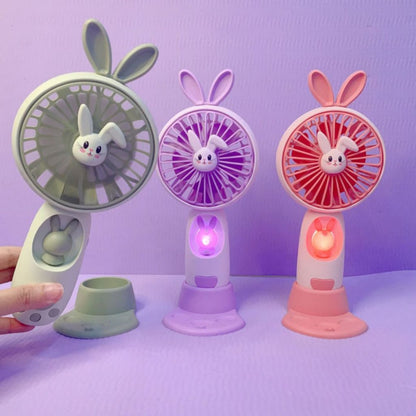 Kipas Angin Genggam Tangan Karakter Bunny Dengan LED + Holder Penyangga HP / Handy Mini Fan Portable Rechargeable Elektrik Motif Kelinci Lucu Travel Size Travelling Outdoor Konser Piknik Pantai Jogging CFD Luar Ruangan Make Up Skincare Multifungsi